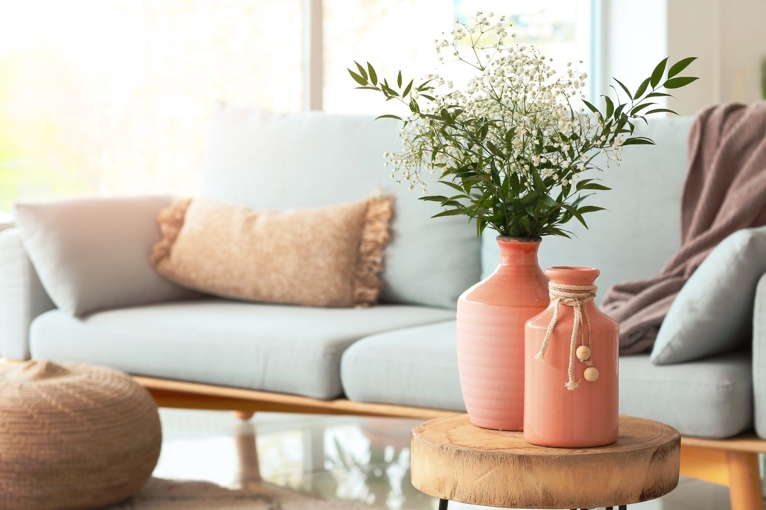oft pink ceramic vases with indoor flowering plants in a cozy living room